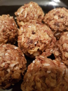 Energy balls with cinnamon, shredded coconut flakes and walnuts.